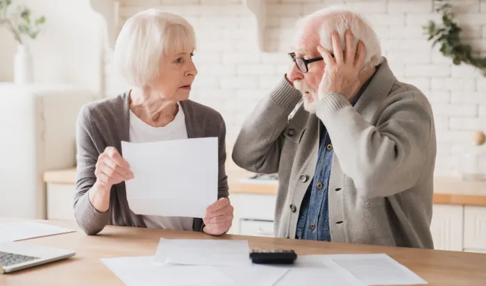 Senior elderly grandparents couple feeling shock sad in debts bankruptcy negative test results mortgage divorce certificate contract pension